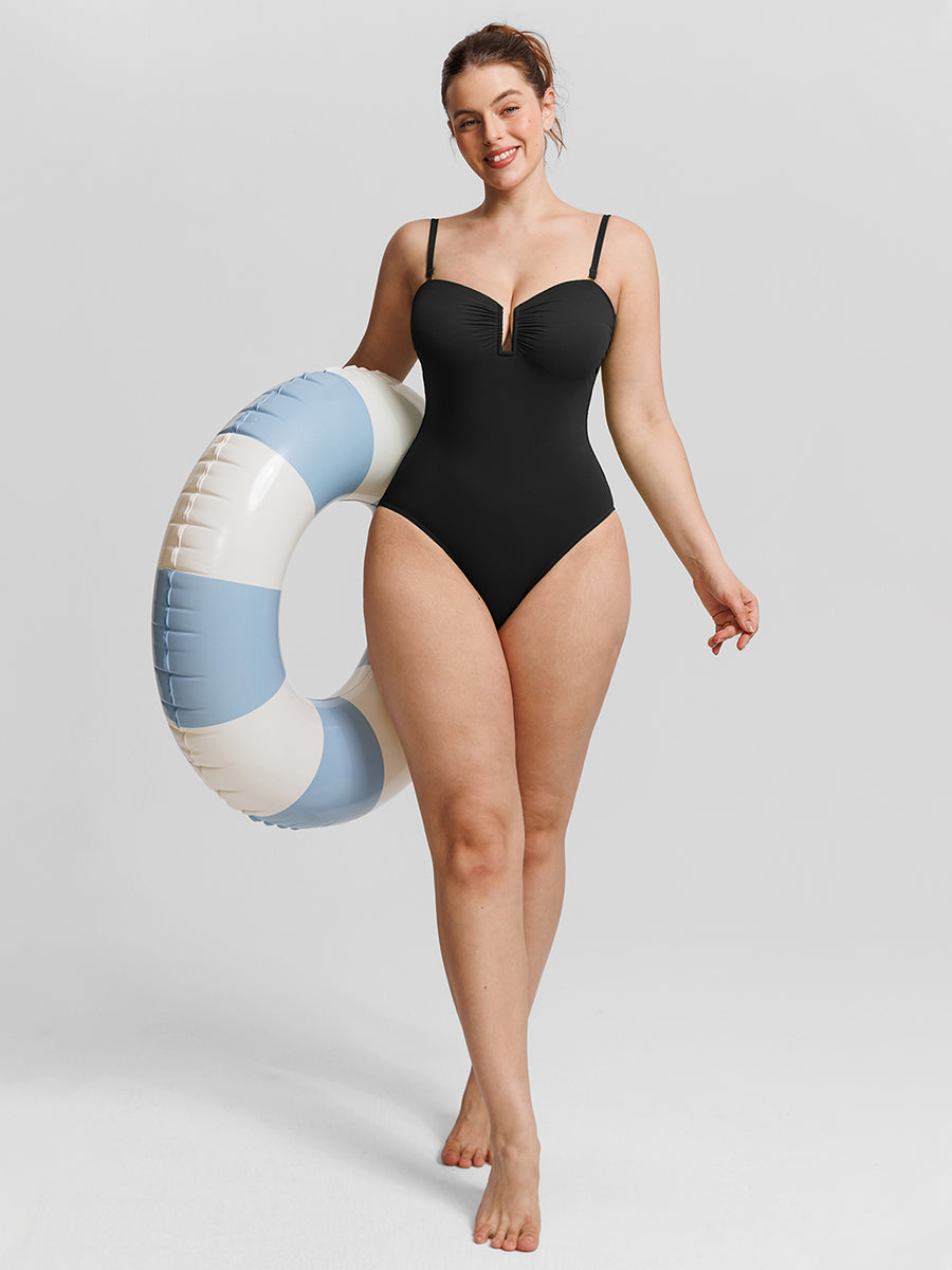 Silhouette One-Piece Swimsuit in black – full-length pose holding a pool float