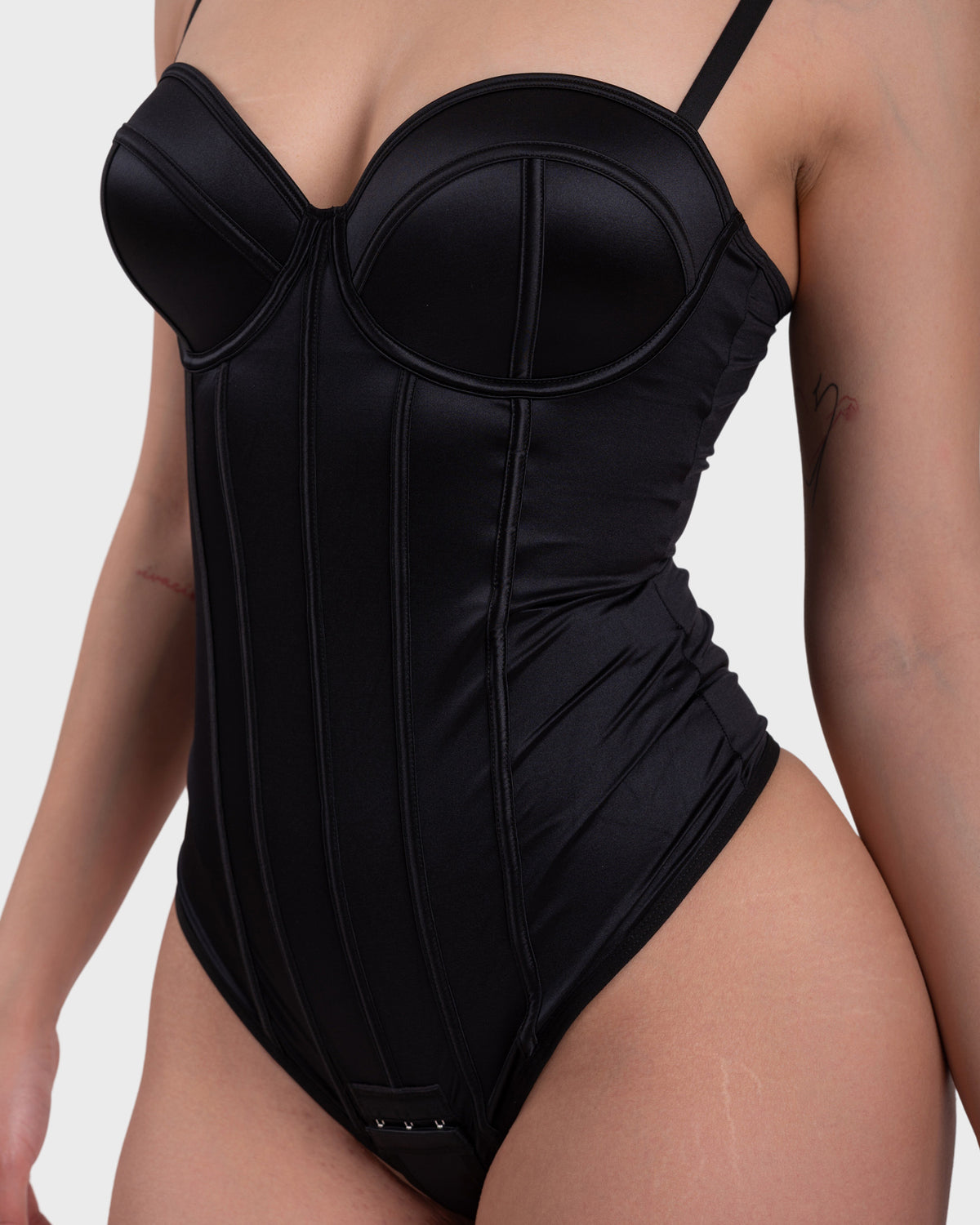 Amelia Corset Bodysuit in black – close-up of the satin corset cups and boning