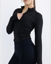 Shop Lily Evolve Contour Long Sleeve Jacket in black, fitted zip-up long sleeve activewear jacket – back three-quarter view