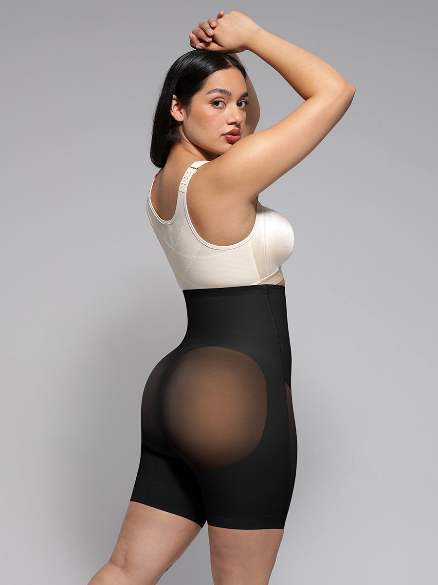 Power Silhouette Shaping Shorts in black – model posing with arms raised