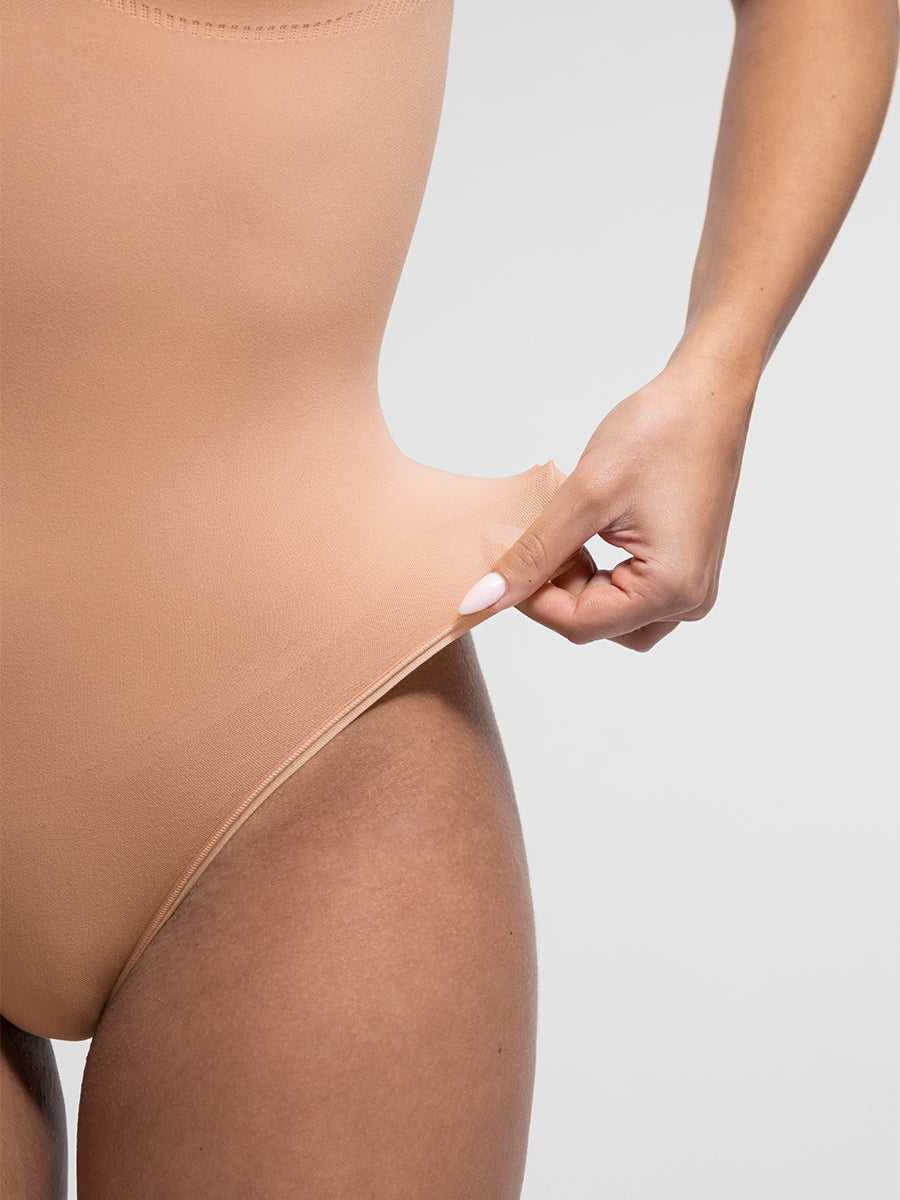 SculptCurve Thong Bodysuit in nude – close-up of the fabric stretch at the leg