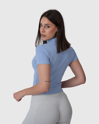 Shop Lily Motion Sculpt Jacket in powder blue, short sleeve zip-up activewear top – back three-quarter view