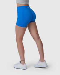 Shop Lily Form Sculpting Shorts in electric blue, high-waisted sculpting biker shorts – back three-quarter view