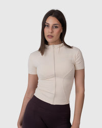 Shop Lily Motion Sculpt Jacket in cream, short sleeve zip-up activewear top – front view