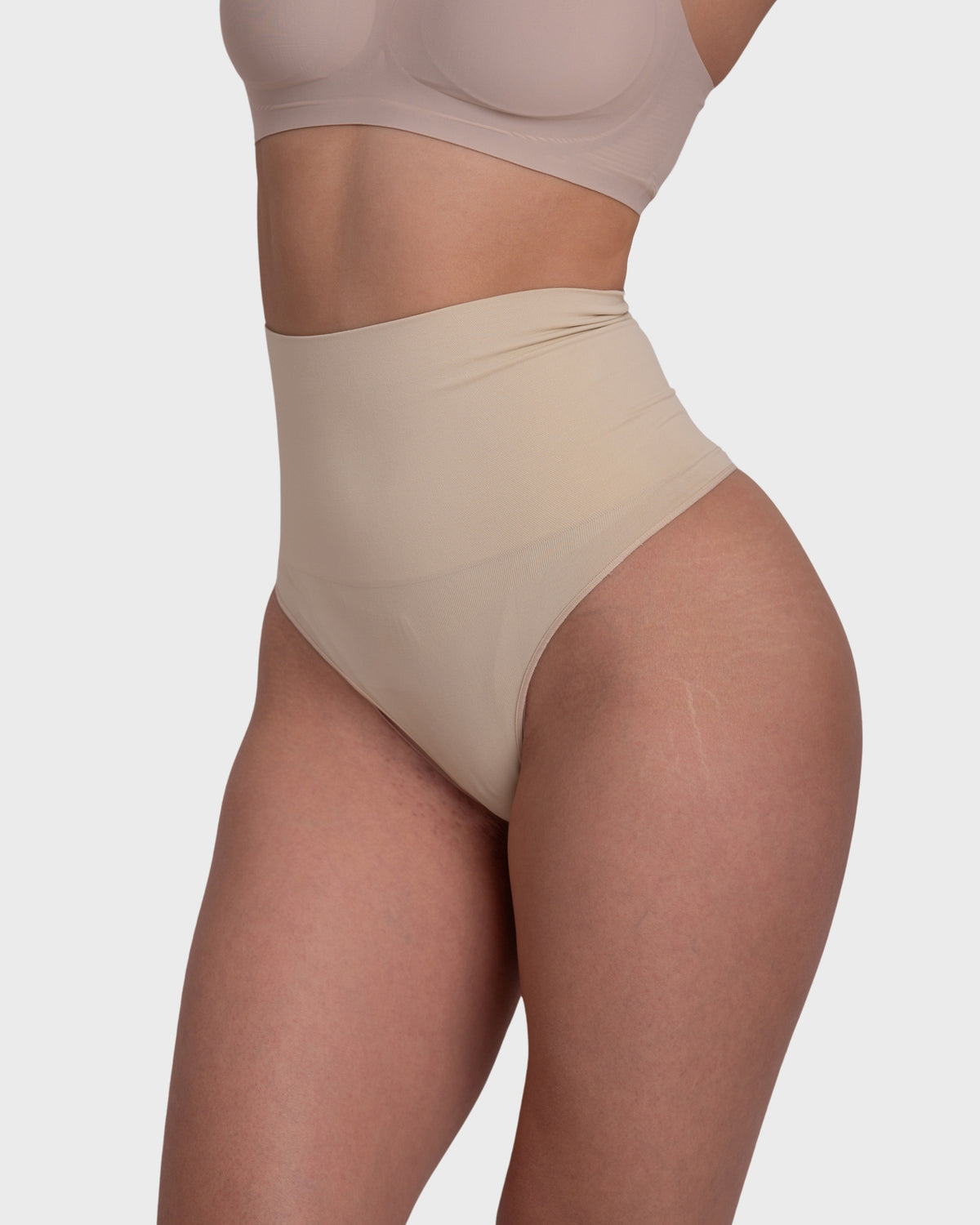 Shop Lily Tummy Control Shaping Thong Panties in nude, high-waisted tummy-control shaping thong – side view