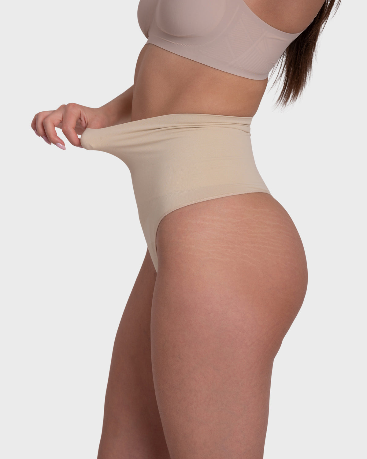 Tummy Control Shaping Thong Panties in nude – close-up of the stretch of the high-rise waistband