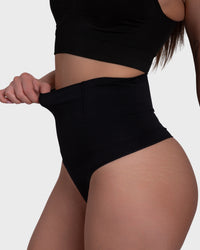 Shop Lily Tummy Control Shaping Thong Panties in black, high-waisted tummy-control shaping thong – close-up of the stretch of the high-rise waistband