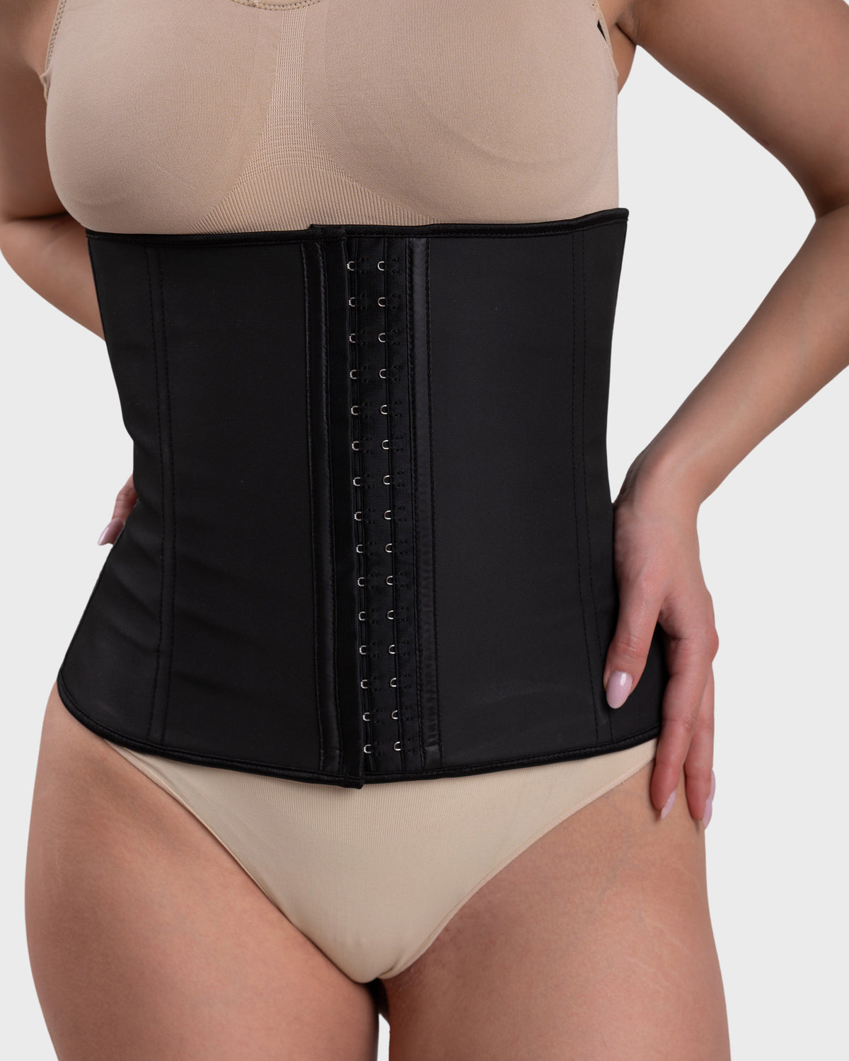 Women's Latex Hourglass Waist Trainer in black – close-up of the front hook-and-eye closure